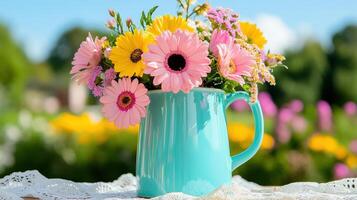 Pastel green color enamel pitcher overflowing with vibrant flowers in a sunny garden setting photo