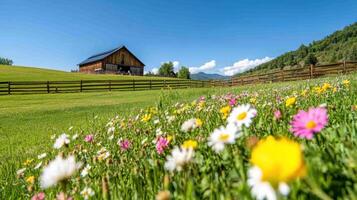 Beautiful rustic barn surrounded by colorful wildflowers and a wooden fence on a sunny day in a serene countryside photo