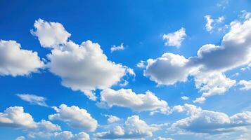 Serene spring sky featuring fluffy white clouds against a bright blue backdrop photo