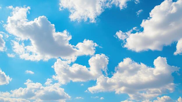 Serene spring sky with soft fluffy clouds and bright blue hues during a tranquil afternoon photo