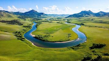 Tranquil landscape of rolling hills with a winding river surrounded by lush greenery under a clear blue sky photo