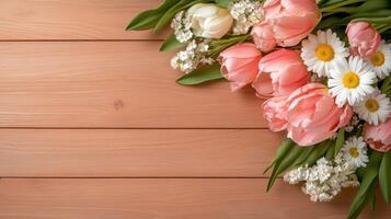 Pastel-colored tulips and daisies arranged on rustic wooden planks for a fresh spring vibe photo