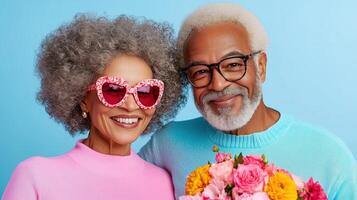 Celebrating love and joy, an elderly couple shares a joyful moment with flowers against a bright blue backdrop photo