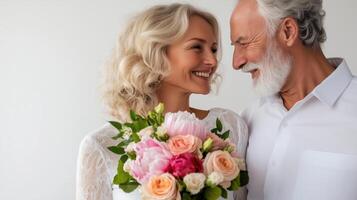 Elderly couple celebrating love with flowers and smiles in a cozy setting during a joyful occasion photo