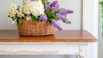 Old wooden table with peeling paint and a basket of vibrant flowers creates a charming rustic decor in a cozy interior photo