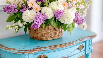 Old wooden table with peeling paint and a vibrant floral arrangement adds charm to the room's decor photo