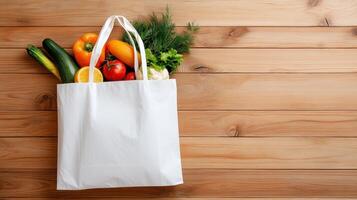 Fresh produce collection in reusable shopping bag on wooden background after market visit photo