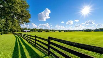 Golden sunlight filters through fields creating a serene atmosphere with a wooden fence and vibrant green grass photo