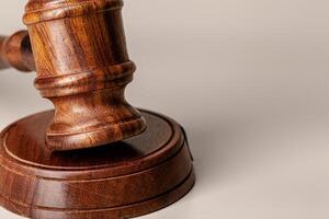 Wooden judges gavel on table close up photo