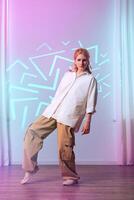 Dance performance with colorful lighting in modern studio setting during evening hours photo