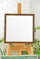 Blank canvas on easel ready for creative expression in bright indoor studio setting filled with natural light photo