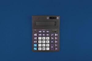 Top view of a calculator isolated on classic blue photo