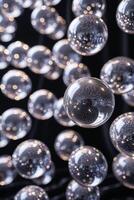 Floating transparent spheres illuminated by soft light in a dark background create a mesmerizing visual effect photo