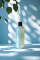 Clear bottle with liquid reflecting light in a serene setting decorated with subtle shadows and plants photo