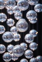 Decorative silver orbs suspended against a dark background create a mesmerizing light effect in an elegant setting photo