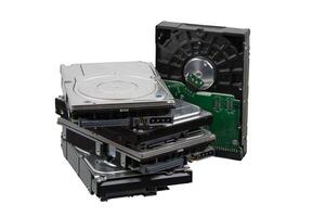 A stack of old, possibly non-functional hard drives, isolated on a white background photo