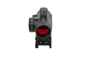 Black tactical sight with a red dot and orange-tinted lens, rail-mounted, commonly used to enhance firearm accuracy, displayed on a white background. photo