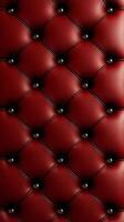 Deep red leather upholstery with a timeless tufted design, evenly spaced buttons, and a rich, glossy texture. photo