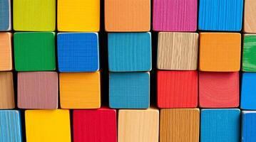 Colorful wooden blocks stacked up in a row photo