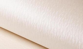 Ivory and cream paper with embossed, rippled texture and elegant wave design. Shiny, pearlescent photo