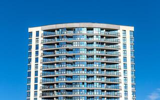 Modern high-rise condominium under development in metropolitan area. Concrete structure with glass photo