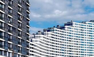 Modern high-rise condominium in downtown metropolis. Concrete structure with wavy, geometric facade, photo