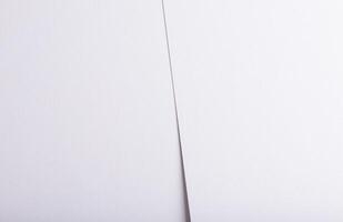 White and off-white designer paper with smooth, delicate texture. Subtle diagonal split creating photo