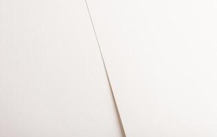 White, beige, and ivory paper with soft texture. Minimal, smooth surface and diagonal lines create photo