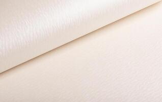 Beige and ivory paper with embossed, rippled texture and pearlescent finish. Shiny, glossy surface photo