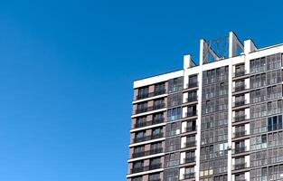 Modern condominium in a metropolitan city. Tall, high-rise building with a concrete facade, photo