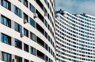 Modern architecture in a developing metropolis. High-rise multistory building with wavy, geometric photo