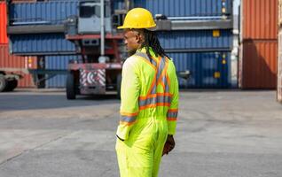 Engineer man in industry containers cargo, Foreman dock worker in hard hat at shipping container yard photo