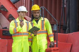 Engineer man Team in Safety Gear Control Containers Box at Industrial Site, Container Yard Workers Discussion at Shipping Yard photo