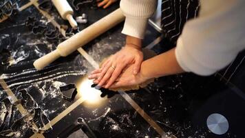 Housewife puts a cookie cutter on the dough and rolls it out with a rolling pin video