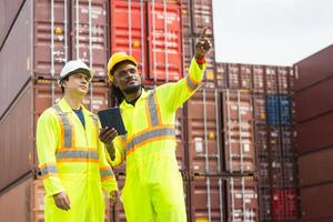 Engineer man Team in Safety Gear Control Containers Box at Industrial Site, Container Yard Workers Discussion in Shipping Yard photo