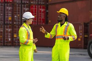 Industrial foreman worker team checking and managing containers boxes at cargo containers shipping, Worker man team control loading containers box from cargo photo