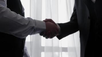 Business handshake in an office, symbolizing partnership and trust between business partners video