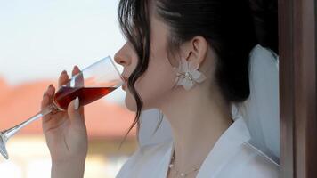 Bride enjoying a drink, elegant close-up with soft lighting and delicate details video