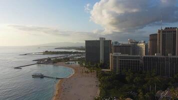 Scenic view of Honolulu s coastline, Fort DeRussy Beach with palm trees, sandy shore, and Diamond Head mountain in the background video