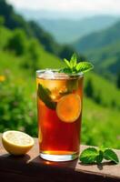 Refreshing iced tea with lemon and mint enjoying mountain view photo