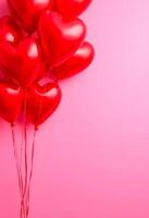 vertical template is pink. Inflatable balloons in the shape of a heart.Place for the text photo