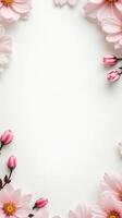 Pink flowers and buds arranged as floral frame on white background. Copy space for greeting card, wedding invitation, or spring design photo