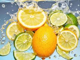Lemon and lime slices in water with bubbles photo