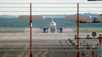 Airliner is taking off, view from the end of the runway. Next plane approaching landing. Two planes in the sky, Tourism and travel concept video