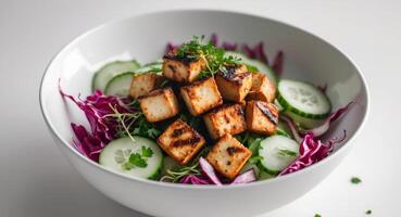 A bowl of tofu and cucumber salad with a side of parsley photo