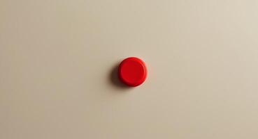 Close up of a Small Red Plastic Calculator Button on a Beige Background. photo