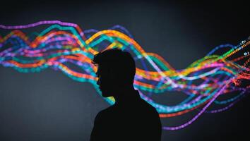 Silhouetted Man Views Colorful Lines Of Code On Dark Background. photo