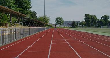 A person running on a running track video