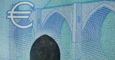 A close up of a euro banknote with a bridge in the background video