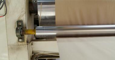 A machine is making a roll of paper video